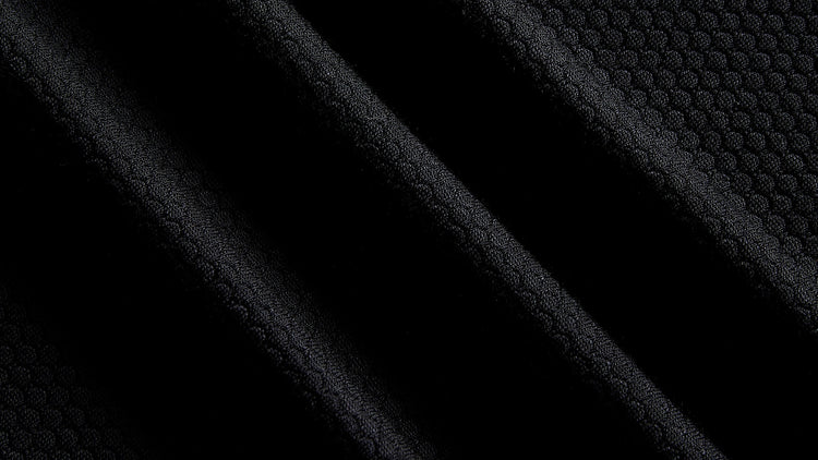 Close up of black merino and Tencel open knit training fabric