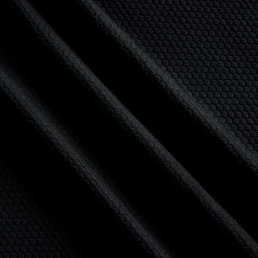 Close up of black merino and Tencel open knit training fabric